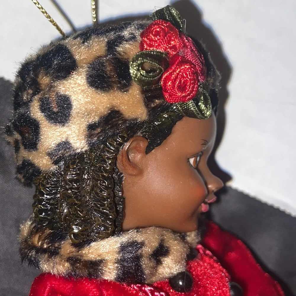 Vintage African American doll ornament with red velvet and leopard fur purse